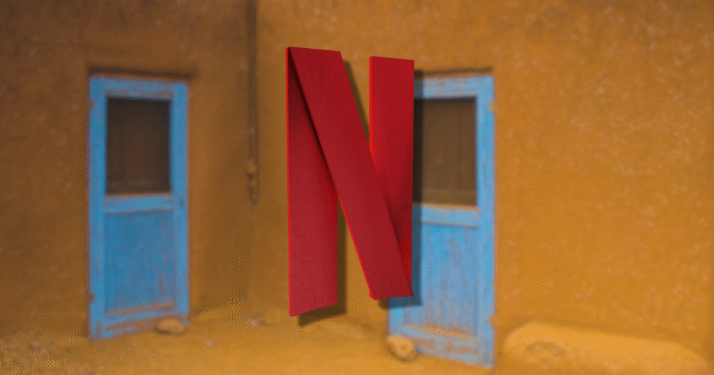 Innovators dilemma in entertainment featuring the red Netflix N logo prominently displayed in the center against a softly focused background of a yellow wall and two blue doors.